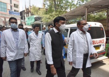 NEW DELHI INDIA APRIL 10 2023 Union Health Minister Mansukh Mandaviya with health care workers during the inspection of a mock drill for COVID 19 preparedness at RML Hospital on April 10 2023 in New Delhi India India began a two day nationwide drill  clipart