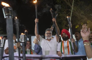 MUMBAI INDIA APRIL 11 2023 Congress activists led by city president Bhai Jagtap Charan Singh Sapra and Mahatma Gandhi Foundation President Tushar Gandhi along with opposition party workers stage a torch rally against the rising inflation unemployment clipart