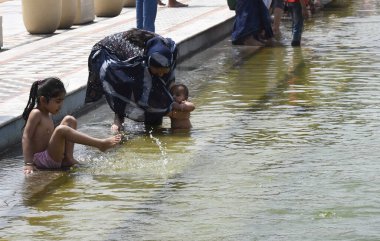 YENİ DELHI INDIA APRIL 14 YIL 2023 Dindar Gurudwara Bangla Sahib 'in kutsal göletine 14 Nisan 2023' te Vaisakhi festivali vesilesiyle daldı.