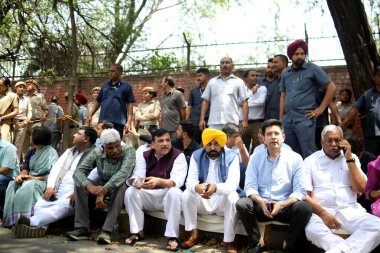 NEW DELHI INDIA APRIL 16 2023 Punjab CM Bhagwant Mann AAP MP Sanjay Singh Raghav Chadha and party leaders sit in support of Delhi CM Arvind Kejriwal while he was appearing before the CBI officials for questioning in connection with the Delhi liquor p clipart