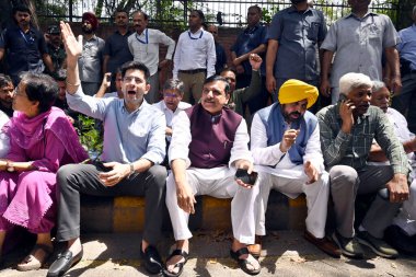 NEW DELHI INDIA APRIL 16 2023 Punjab CM Bhagwant Mann AAP MP Sanjay Singh Raghav Chadha and party leaders sit in support of Delhi CM Arvind Kejriwal while he was appearing before the CBI officials for questioning in connection with the Delhi liquor p clipart