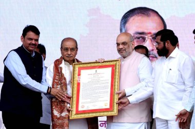 NAVI MUMBAI INDIA APRIL 15 2023 Union Home Minister Amit Shah along with Maharashtra CM Eknath Shinde and Dy CM Devendra Fadnavis conferred Maharashtra Bhushan to Dr Appasaheb Dharmadhikari at Corporate Park Kharghar on April 15 2023 in Navi Mumbai I clipart