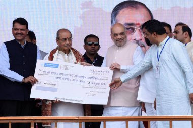 NAVI MUMBAI INDIA APRIL 15 2023 Union Home Minister Amit Shah along with Maharashtra CM Eknath Shinde and Dy CM Devendra Fadnavis conferred Maharashtra Bhushan to Dr Appasaheb Dharmadhikari at Corporate Park Kharghar on April 15 2023 in Navi Mumbai I clipart