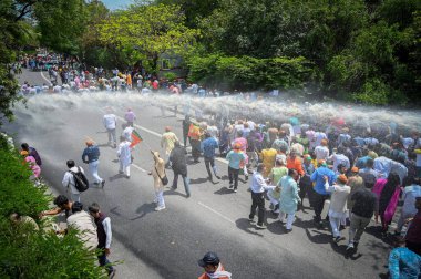 NEW DELHI INDIA APRIL 17 2023 Delhi police uses water canons to disperse off the crowd as BJP supporters protests against the Delhi Government under the leadership of Delhi BJP President Virendra Sachdeva at Civil Lines on April 17 2023 in New Delhi  clipart