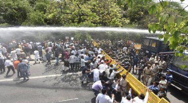 NEW DELHI INDIA APRIL 17 2023 Delhi police uses water canons to disperse off the crowd as BJP supporters protests against the Delhi Government under the leadership of Delhi BJP President Virendra Sachdeva at Civil Lines on April 17 2023 in New Delhi  clipart