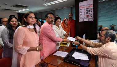 NEW DELHI INDIA APRIL 18 2023 Delhi BJP Candidates for MCD Mayor Election Shikha Rai and for Deputy Mayor Soni Pandey along with BJP Delhi General Secretary Harsh Malhotra and other leaders filing their nomination to municipal secretary Siva Prasad K clipart