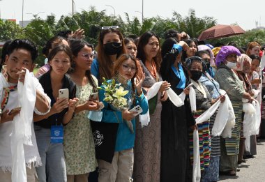 NEW DELHI INDIA APRIL 19 2023 Devotees and followers gather in large numbers at the IGI Airport to welcome the Dalai Lama Tibetan spiritual leader on his visit to take part in the Global Buddhism Summit on April 19 2023 in New Delhi India The event i clipart