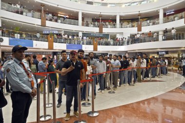 NEW DELHI INDIA APRIL 20 2023 Customers wait in line outside the new Apple Inc store ahead of its opening at Select City Walk at Saket on April 20 2023 in New Delhi India Apple CEO Tim Cook launched India s second Apple store today in Delhi  clipart