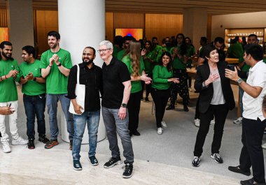 NEW DELHI INDIA APRIL 20 2023 Customers wait in line outside the new Apple Inc store ahead of its opening at Select City Walk at Saket on April 20 2023 in New Delhi India Apple CEO Tim Cook launched India s second Apple store today in Delhi  clipart