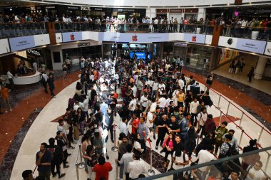 NEW DELHI INDIA APRIL 20 2023 Customers wait in line outside the new Apple Inc store ahead of its opening at Select City Walk at Saket on April 20 2023 in New Delhi India Apple CEO Tim Cook launched India s second Apple store today in Delhi  clipart