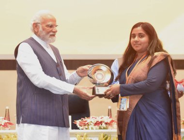 NEW DELHI INDIA APRIL 21 2023 Prime Minister Narendra Modi presenting PMs Award for Excellence in Public Administration 2022 to Dr M Aarthi Collector Kancheepuram Tamil Naidu during the Valedictory Session and Awards Ceremony  clipart