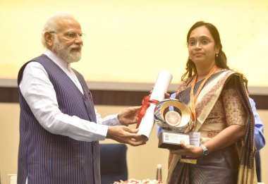 NEW DELHI INDIA APRIL 21 2023 Prime Minister Narendra Modi presenting PMs Award for Excellence in Public Administration 2022 to Bhavya Mittal Collector Burhanpur Madhya Pradesh during the Valedictory Session and Awards Ceremony clipart