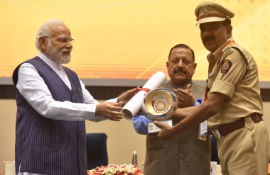 NEW DELHI INDIA APRIL 21 2023 Prime Minister Narendra Modi presenting PMs Award for Excellence in Public Administration 2022 to Shirish Sadeshpande SP Solapur Maharashtra during the Valedictory Session and Awards Ceremony  clipart