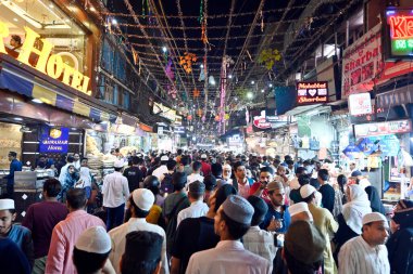 NEW DELHI INDIA APRIL 21 2023 Shoppers at a market on the eve of Eid al Fitr festival near Jama Masjid on April 21 2022 in New Delhi India on Friday clipart