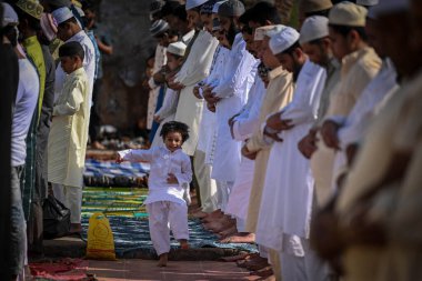 NEW DELHI, INDIA: APRIL 22, 2023 - Muslims offer Eid al Fitr prayers at the 14th century Feroz Shah Kotla Jami Mosque marking the end of the holy fasting month of Ramadan on April 22 2023 in New Delhi India.  clipart