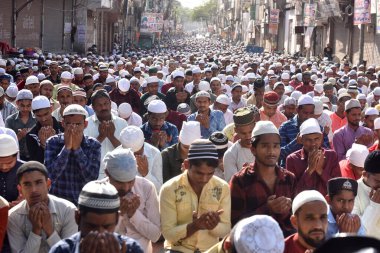 NEW DELHI, INDIA: APRIL 22, 2023 - Muslims offer prayers at Gandhi Nagar main road outside the Masjid on the occasion of Eid ul Fitr in East Delhi on April 22 2023 in New Delhi India Muslims around the world are getting into the festive Eid spirit.  clipart