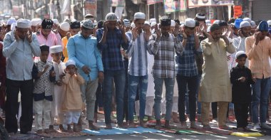 NEW DELHI, INDIA: APRIL 22, 2023 - Muslims offer prayers at Gandhi Nagar main road outside the Masjid on the occasion of Eid ul Fitr in East Delhi on April 22 2023 in New Delhi India Muslims around the world are getting into the festive Eid spirit.  clipart