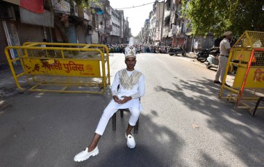 NEW DELHI, INDIA: APRIL 22, 2023 - Muslims offer prayers at Gandhi Nagar main road outside the Masjid on the occasion of Eid ul Fitr in East Delhi on April 22 2023 in New Delhi India Muslims around the world are getting into the festive Eid spirit.  clipart