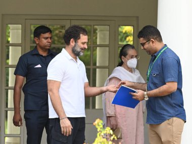 NEW DELHI INDIA APRIL 22 2023 Congress leader Rahul Gandhi hands over the keys of 12 Tughlak Lane bungalow to a CPWD official in the presence of Sonia Gandhi on April 22 2023 in New Delhi India Gandhi who was disqualified from Lok Sabha last month fo clipart