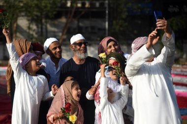 NAVI MUMBAI INDIA APRIL 22 2023 Families pose for pictures after offering Eid ul Fitr Namaz at Nerul on April 22 2023 in Navi Mumbai India Muslims around the world are getting into the festive Eid spirit as the holy month of Ramadan concludes The fes clipart