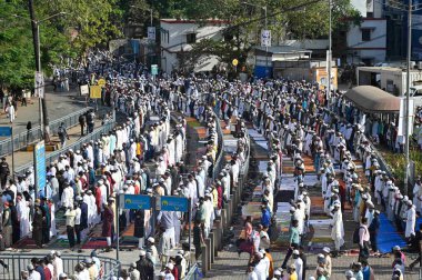 MUMBAI INDIA APRIL 22 2023 People offer namaz outside the station on the occasion of Eid al Fitr at Bandra on April 22 2023 in Mumbai India Muslims around the world are getting into the festive Eid spirit as the holy month of Ramadan concludes The fe clipart