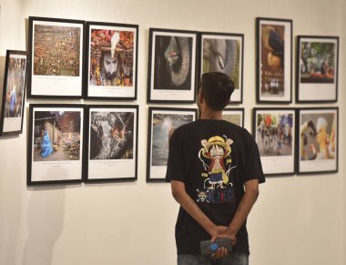 NEW DELHI, INDIA: APRIL 23, 2023 - People visit a Big Picture Exhibition 2023 organized by Working News Cameraman Association on April 23 2023 in New Delhi India.  clipart