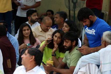 NEW DELHI INDIA APRIL 25 2023 Wrestlers Bajrang Punia Vinesh Phogat Sakshi Malik along with Khap Panchayat members during a protest against WFI President Brij Bhushan Sharan Singh over different allegations at Jantar Mantar on April 25 2023 in New De clipart