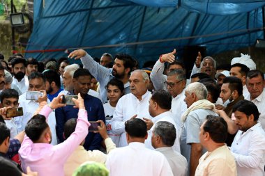 NEW DELHI INDIA APRIL 25 2023 Former Haryana Chief Minister Bhupinder Singh Hooda with Wrestlers Bajrang Punia Vinesh Phogat along with Khap Panchayat members during a protest against WFI President Brij Bhushan Sharan Singh over different allegations clipart