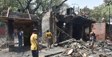 NEW DELHI INDIA APRIL 25 2023 Charred remains of a shop are seen after a massive fire broke out that gutted shops and roadside stalls at the mini market area of Sarojini Nagar on April 25 2023 in New Delhi India Five fire tenders were rushed to the s clipart