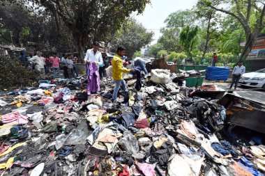 NEW DELHI INDIA APRIL 25 2023 Charred remains of a shop are seen after a massive fire broke out that gutted shops and roadside stalls at the mini market area of Sarojini Nagar on April 25 2023 in New Delhi India Five fire tenders were rushed to the s clipart