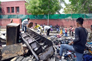 NEW DELHI INDIA APRIL 25 2023 Charred remains of a shop are seen after a massive fire broke out that gutted shops and roadside stalls at the mini market area of Sarojini Nagar on April 25 2023 in New Delhi India Five fire tenders were rushed to the s clipart