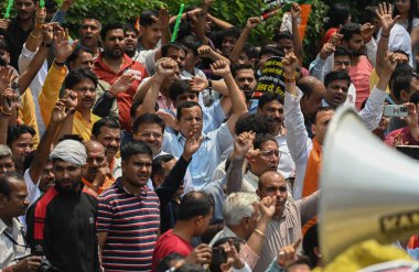 NEW DELHI INDIA: APRIL 27 2023 - Delhi BJP workers raise slogans during a protest against Delhi Chief Minister Arvind Kejriwal accusing him of spending crores on the renovation of his official residence on April 27 2023 in New Delhi India. clipart