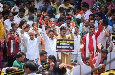 NEW DELHI INDIA: APRIL 27 2023 - Delhi BJP workers raise slogans during a protest against Delhi Chief Minister Arvind Kejriwal accusing him of spending crores on the renovation of his official residence on April 27 2023 in New Delhi India. clipart