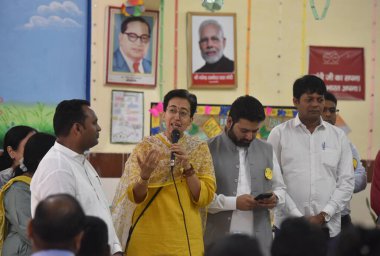 NEW DELHI, INDIA: APRIL 30, 2023 - Delhi Education Minister Atishi and MCD Deputy Mayor Aaley Mohammad Iqbal talking with parents and students take part in Delhi Government and MCD s joint Mega PTM and interact. clipart