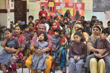 NEW DELHI, INDIA: APRIL 30, 2023 - Delhi Education Minister Atishi and MCD Deputy Mayor Aaley Mohammad Iqbal talking with parents and students take part in Delhi Government and MCD s joint Mega PTM and interact. clipart