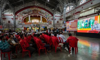 MUMBAI INDIA APRIL 30 2023 Porters Coolie s of Mumbai Central railway station listening to the 100th Episode of Mann Ki Baat by PM Narendra Modi at Mumbai Central railway station on April 30 2023 in Mumbai India In the 100th episode of Mann ki Baat  clipart