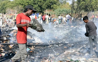 A massive fire broke out in the slum area of Kanawani under the Indirapuram police station, on December 14, 2024 in Ghaziabad, India. Thick clouds of smoke billowing from the site are visible from afar.  clipart