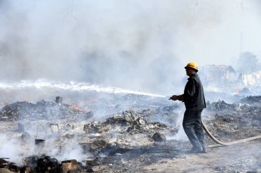 A massive fire broke out in the slum area of Kanawani under the Indirapuram police station, on December 14, 2024 in Ghaziabad, India. Thick clouds of smoke billowing from the site are visible from afar.  clipart