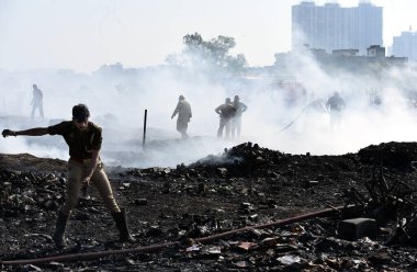 A massive fire broke out in the slum area of Kanawani under the Indirapuram police station, on December 14, 2024 in Ghaziabad, India. Thick clouds of smoke billowing from the site are visible from afar.  clipart