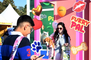 NEW DELHI, INDIA - DECEMBER 14, 2024: People along with their pets participate in two-days PET Festival Pet Fed, at NSIC Ground, on December 14, 2024 in New Delhi, India. (Photo by Salman Ali/Hindustan Times) clipart