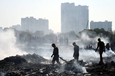 A massive fire broke out in the slum area of Kanawani under the Indirapuram police station, on December 14, 2024 in Ghaziabad, India. Thick clouds of smoke billowing from the site are visible from afar.  clipart