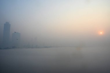 NEW DELHI INDIA DECEMBER 17 2024 A view of Yamuna River covered in fog near Kalindi Kunj on December 17 2024 in New Delhi India Delhi NCR witnessed severe smog and drastically reduced visibility on morning as air quality plummeted back into the sever clipart