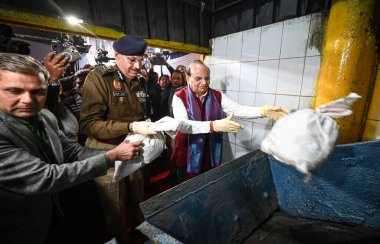 NEW DELHI INDIA DECEMBER 17 2024 Vinai Kumar Saxena Lieutenant Governor of Delhi Delhi along with Delhi Police commissioner Sanjay Arora destroys the illegal drugs during an Illegal Drug Destruction event at a Facility in Jahangirpuri on December 17  clipart