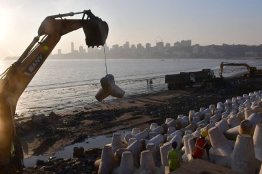 MUMBAI INDIA DECEMBER 17 2024 Workers install new tetrapods near the Coastal Road project at Marine Drive on December 17 2024 in Mumbai India 13 000 New Tetrapods Installed on Marine Drive as Part of Coastal Road Project Tetrapods were removed from t clipart