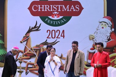 KOLKATA INDIA DECEMBER 19 2024 West Bengal Chief Minister Mamata Banerjee greets in the inaugural ceremony of the Kolkata Christmas Festival in presence of Revd Paritosh Canning R Minister Indranil Sen 2R at Allen Park Park Street on December 19 2024 clipart