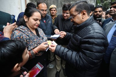 NEW DELHI INDIA DECEMBER 23 2024 AAP Convenor Arvind Kejriwal Delhi Chief Minister Atishi meeting people door to door for registration of Mahila Samman Yojna and Sanjeevni Yojna at Kidwai Nagar ahead of Delhi Assembly Election on December 23 2024 in  clipart