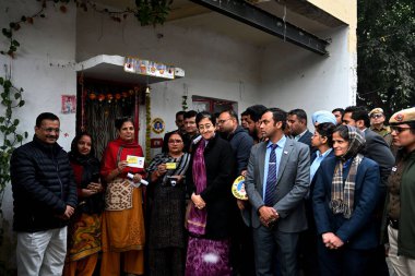 NEW DELHI INDIA DECEMBER 23 2024 AAP Convenor Arvind Kejriwal Delhi Chief Minister Atishi meeting people door to door for registration of Mahila Samman Yojna and Sanjeevni Yojna at Kidwai Nagar ahead of Delhi Assembly Election on December 23 2024 in  clipart