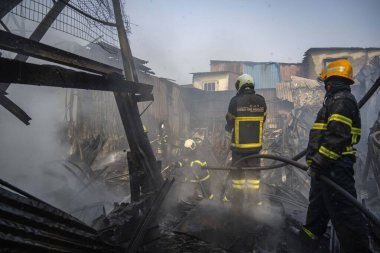 MUMBAI, INDIA - DECEMBER 28, 2024: Massive fire broke out to scrape and plastic materials iGodowns at Wajid Ali Compound, Khairani Road, Sakinaka, on December 28, 2024 in Mumbai, India. Fire Brigade officials reported no injuries. clipart