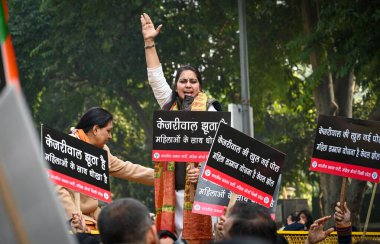 NEW DELHI, INDIA - DECEMBER 26, 2024: Members of Delhi BJP Mahila Morcha stage a protest near former Delhi chief minister and AAP national convenor Arvind Kejriwal's residence, on December 26, 2024 in New Delhi, India.  clipart