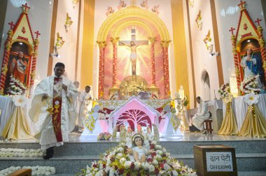 NOIDA, INDIA - DECEMBER 25, 2024: Devotees offer prayers inside a St. Mary's church at Sector 34 on the occasion of Christmas, on December 25, 2024 in Noida, India. (Photo by Sunil Ghosh/Hindustan Times  clipart